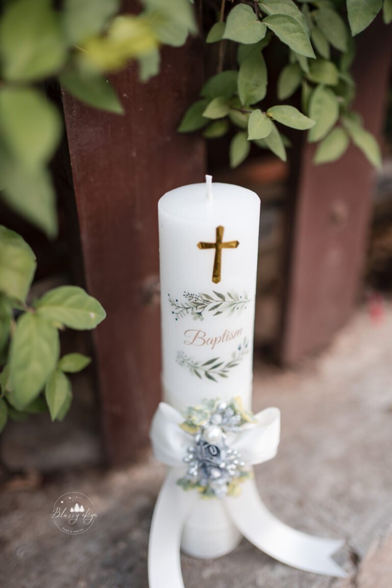 Photo of a beautifully decorated baptism candle with intricate designs.