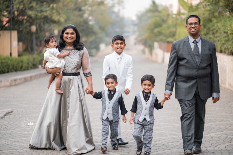 Big family with four children posing naturally during the baptism of their youngest member.