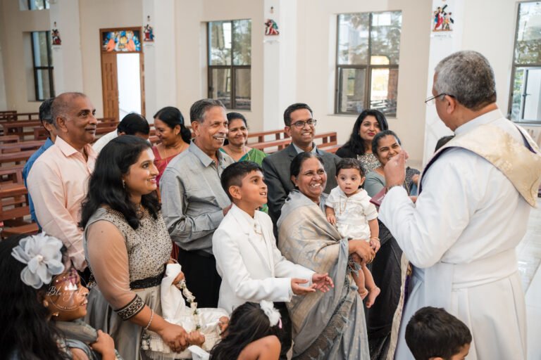 Baptism ceremony taking place in India, showcasing cultural traditions and attire.