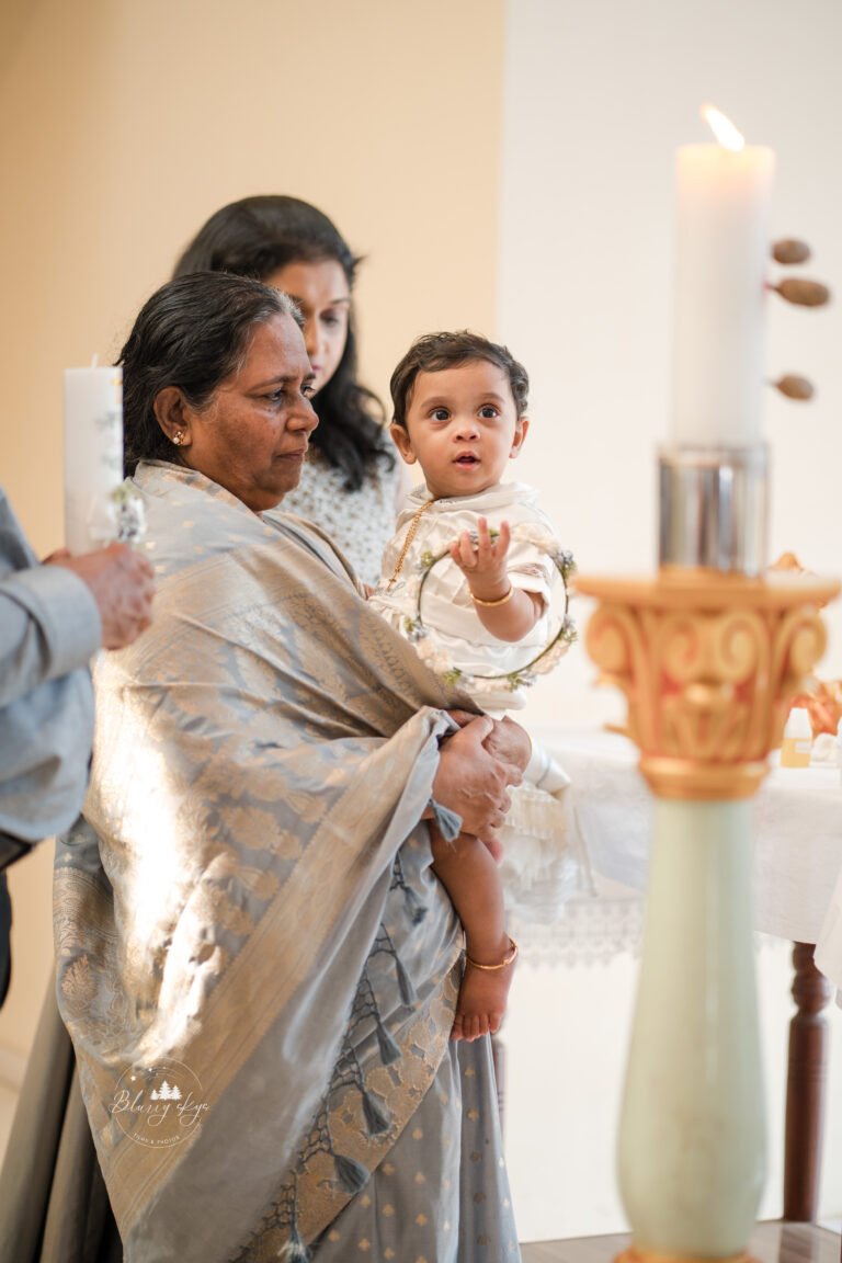 Baby attentively gazing at a candle.