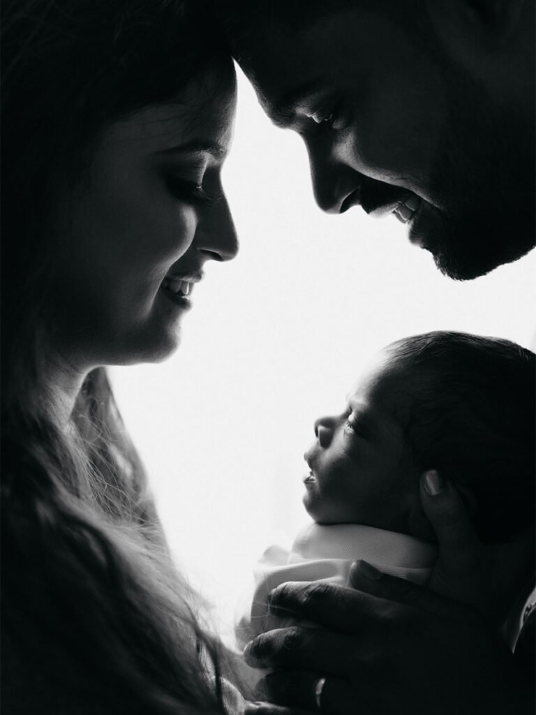 Silhouette image of a family with their newborn child.