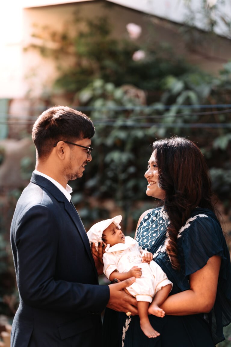 A candid couple photo of a couple with their newborn baby during his baptism day.