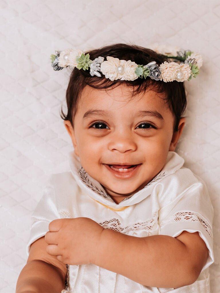 Cute baby portrait wearing a tiara/crown and smiling.