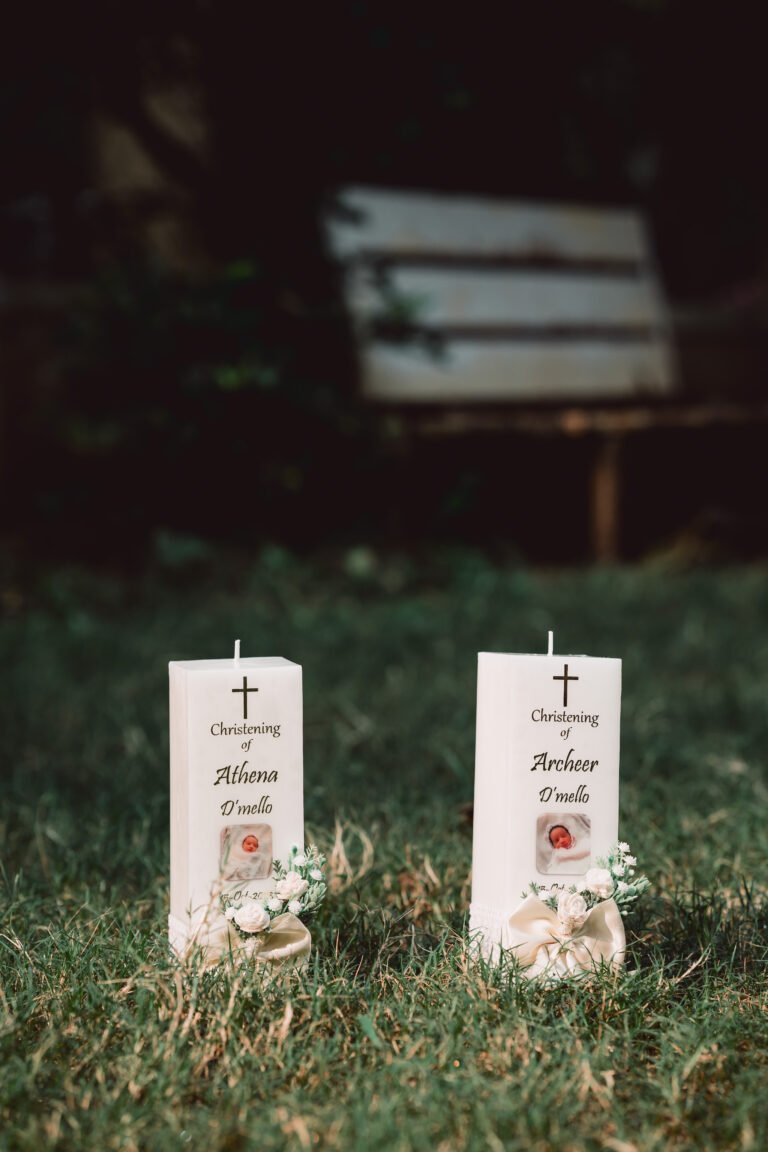 Beautifully captured baptism candle on green grass, aesthetic and serene baptism photography, unique christening ceremony detail