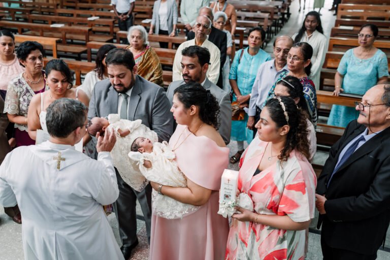 The priest blessing twin babies at the church