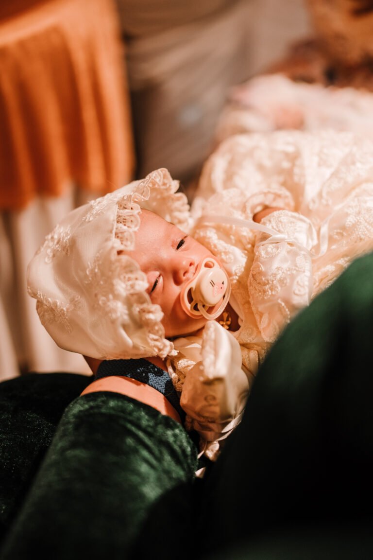 candid photograph of a baby sleeping with pacifiers