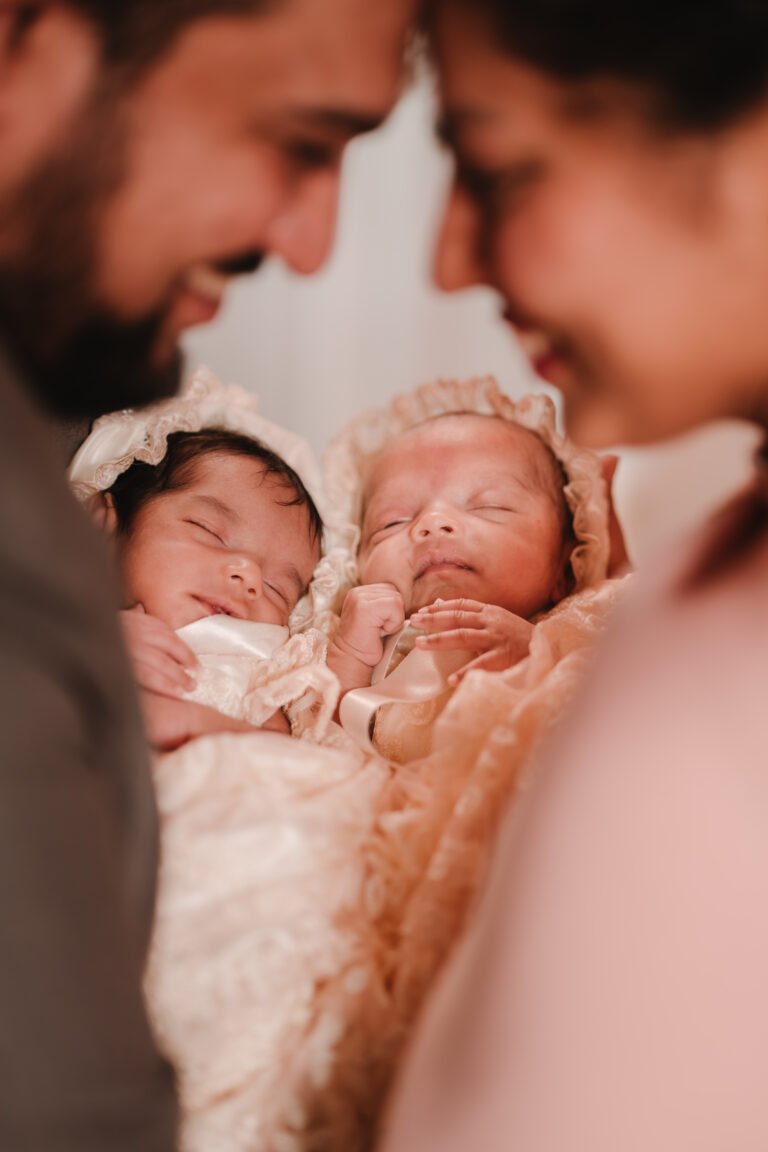 A couple posing with twin babies, a creative pose idea