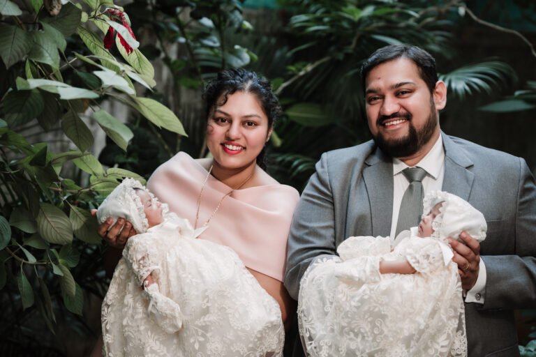 A perfectly captured family portrait of a couple with twins, celebrating their special day