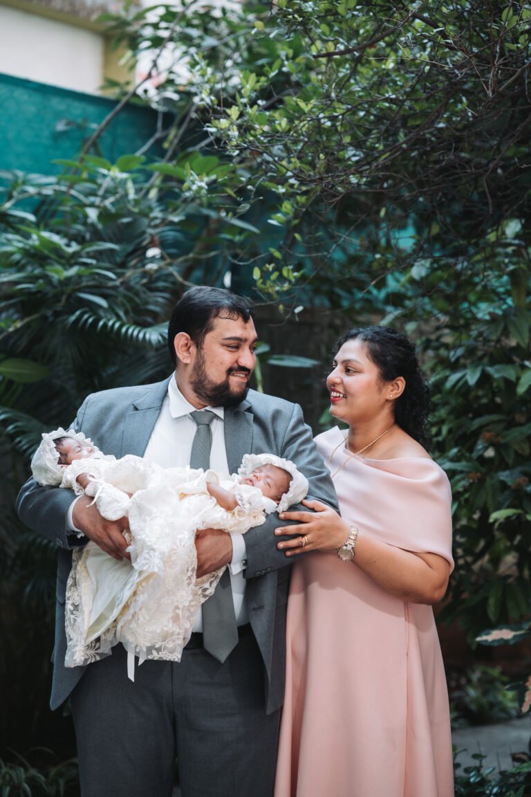 A couple posing with their twin babies, capturing a candid and cherished moment