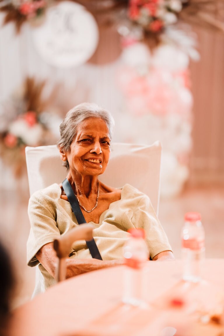 Candid photography of a beautiful grandmother at the reception, capturing her joy and elegance