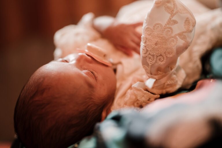 Adorable baby with a pacifier in their mouth, captured during a quiet moment