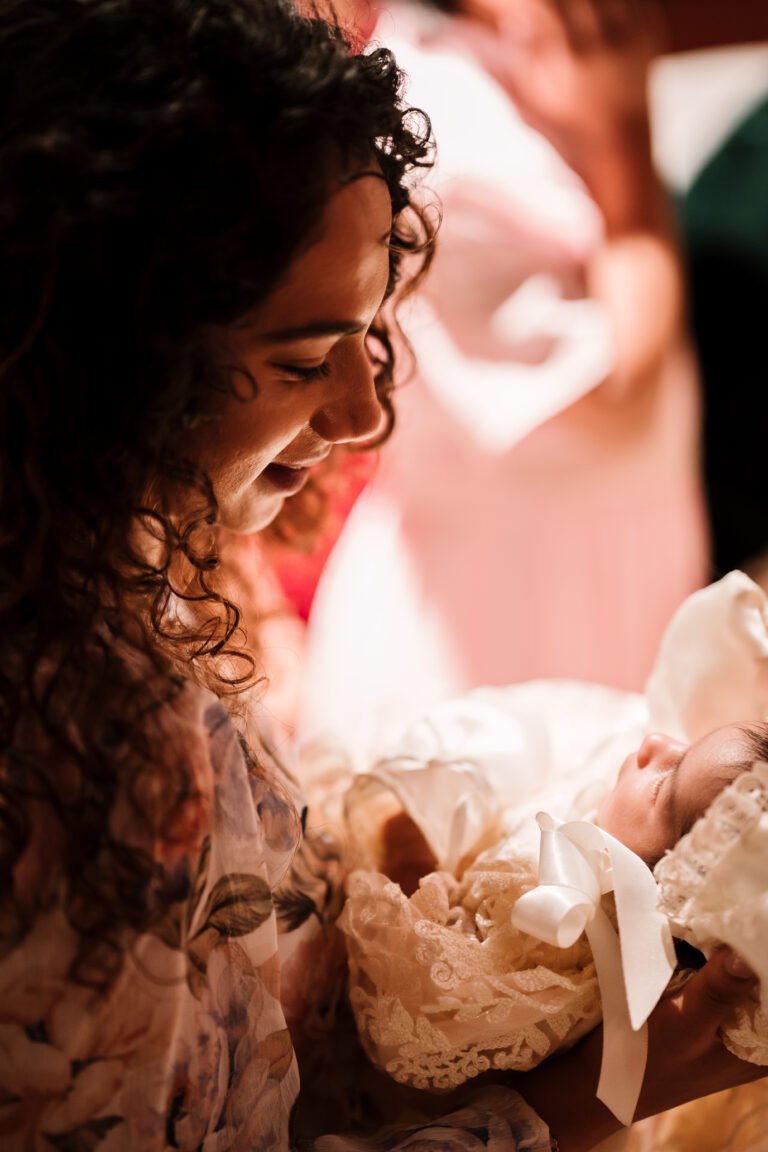 A woman holding a baby, beautifully and candidly captured, showcasing a tender and heartfelt moment.