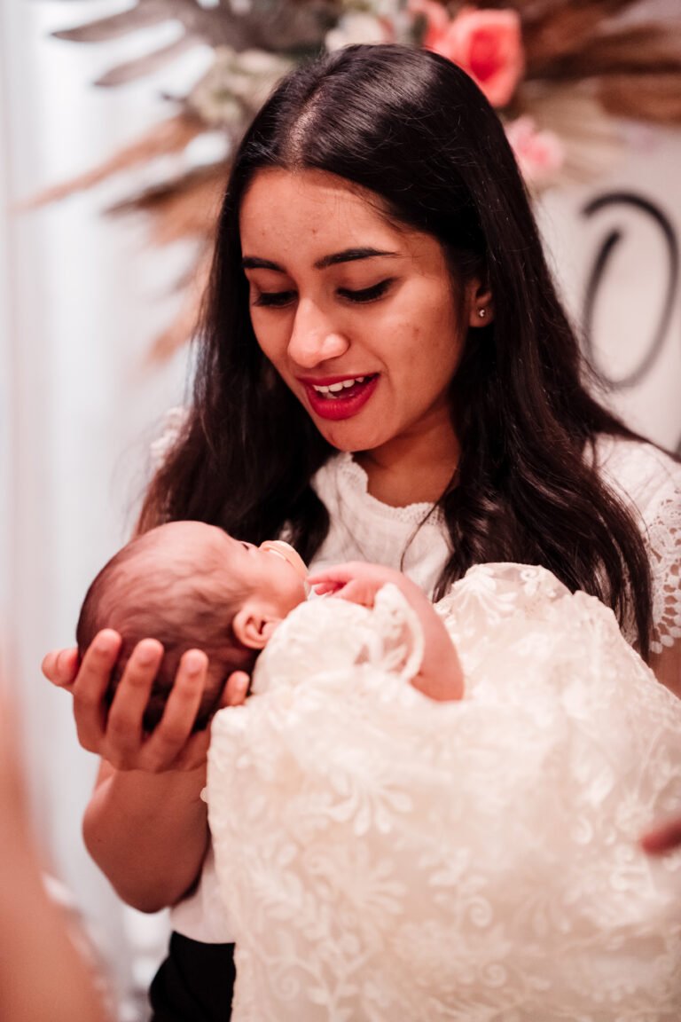 A beautiful girl holding a baby at the reception