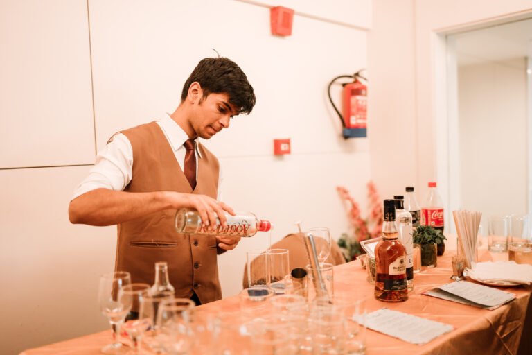 A candid shot of a bartender skillfully making a drink