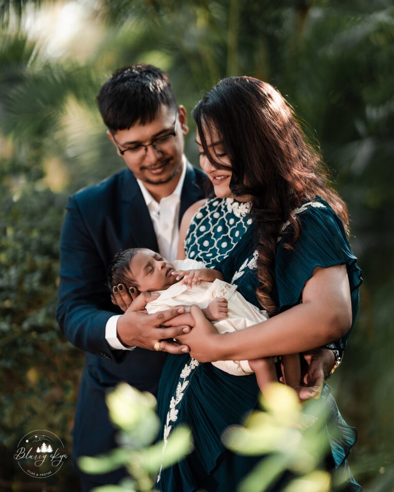 Family portrait of couple with newborn baby on baptism day